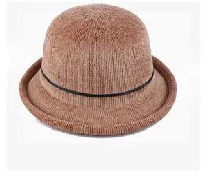 Top angle display of a brown knitted winter bucket hat with a thin black decorative belt