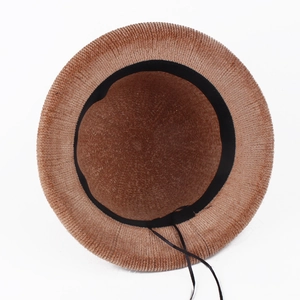 Detailed interior of a brown knitted hat showing the adjustable drawstring and inner sweatband
