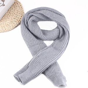 Detailed view of gray ribbed knit scarf with thick textured weave on a white background