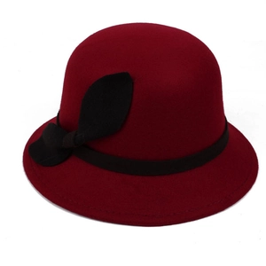 Close-up of vintage wine red wool cloche hat with black ribbon and bow detail