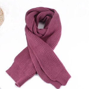 Close-up of deep purple ribbed knit scarf with warm thick texture and ribbed pattern