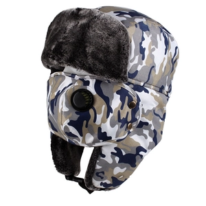 Detail of winter trapper hat with camo pattern, ear flaps, and matching face mask