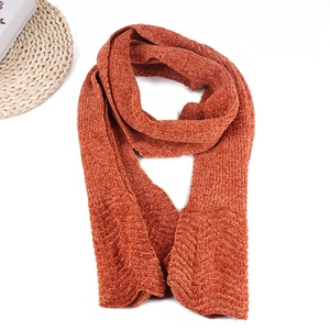 Detail of rust red winter scarf featuring thick chunky knit and warm vertical ribbing textures