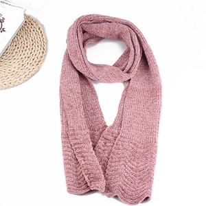 Close-up of pink chenille knitted scarf with ribbed texture and wavy edge design