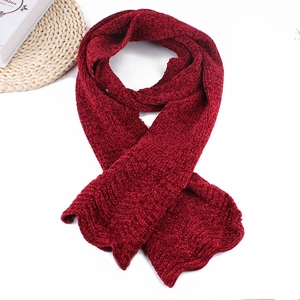Detail view of thick dark red chenille knitted scarf with soft chunky texture