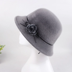 Detail view of winter faux mink fur hat with plush flower and black leather band decoration
