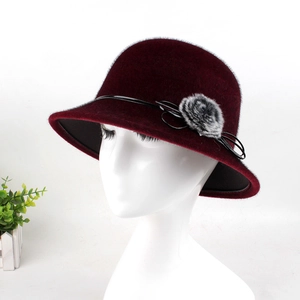Detail of burgundy wool cloche hat featuring black leather band and faux fur flower