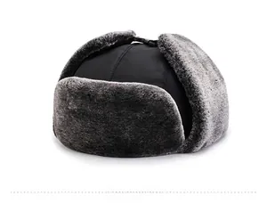 Close-up of windproof winter trapper hat with grey faux fur lining and buckle strap