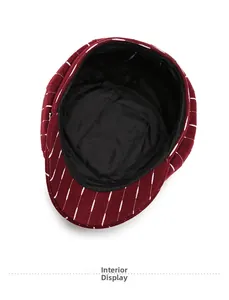 Detailed view of red striped newsboy hat interior lining and black sweatband feature
