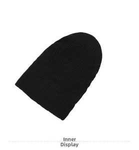 Detail showing the thick ribbed knit texture and soft inner lining of the black beanie hat