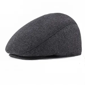 Detailed close-up of dark grey twill fabric and texture on the warm men's winter cap