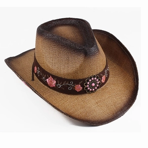 Detailed texture of woven straw cowboy hat with pink floral embroidery and vintage bead buckle