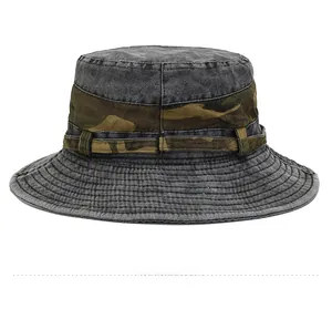 Detail showing high-quality stitching on dark gray washed denim and camouflage outdoor hat
