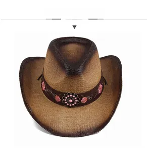 Detailed top view of brown straw cowboy hat with pink floral embroidery and beadwork