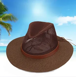 Detail of brown wide-brimmed straw hat with breathable mesh crown and leather strap