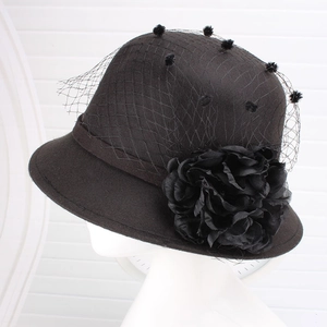 Detail of vintage wool felt cloche hat with floral mesh veil on white mannequin