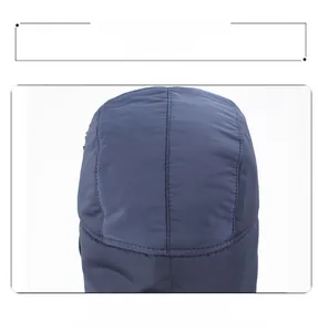 Detailed view of heavy-duty stitching and windproof fabric on a winter bomber hat