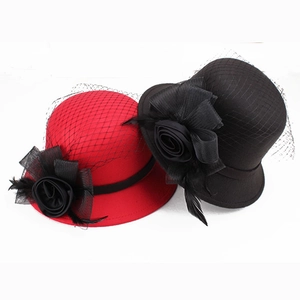 Detail of red and black felt hats with mesh veil and satin rose flower accents