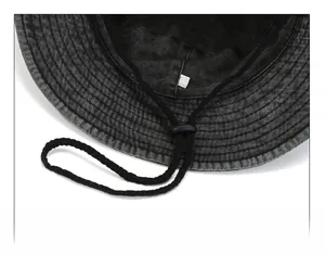 Detail of adjustable windproof drawstring and buckle on washed denim outdoor hat