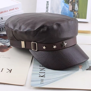 Detail of dark brown PU leather flat top cap featuring silver metal star studs on band