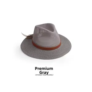 Detail of premium gray straw hat featuring breathable mesh crown and brown leather band