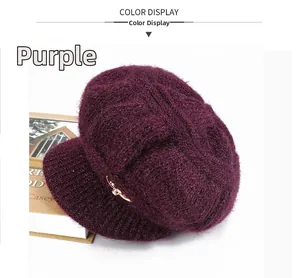 Detail view of purple knit newsboy cap with fuzzy mohair texture and golden metal buckle