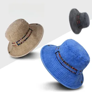 Detail of outdoor wide brim sun hats in khaki, blue and grey with woven ethnic band