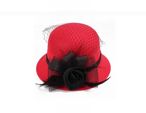 Close-up of red wool cloche hat with black net veil, silk rose and feather detail