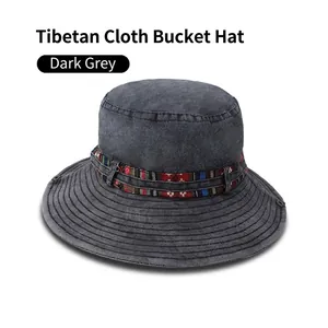 Detail of dark gray washed canvas bucket hat featuring ethnic pattern embroidery band