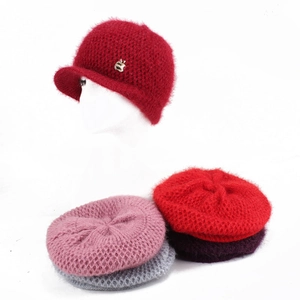 Detailed view of colorful crochet knit beanies with soft mohair texture and metal accent