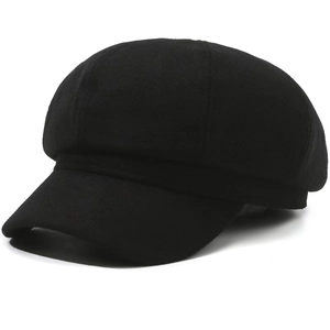 Detail shot of the felt texture and stiff brim on a black classic newsboy cap