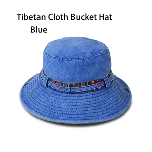 Detail of blue washed cotton bucket hat with ethnic pattern ribbon and metallic buckle
