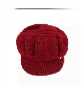 Front view of deep red knitted peaked beret for women with metal button detail