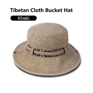 Detail of khaki outdoor bucket hat featuring ethnic woven band and breathable eyelets