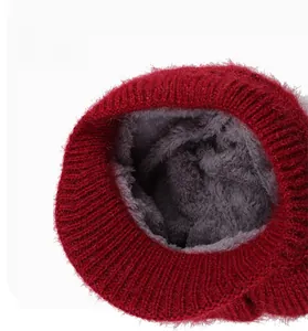 Detail of red winter knit hat showing thick grey fleece lining for extra warmth