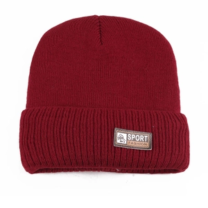 Detail of burgundy ribbed knit winter beanie featuring a brown sport fashion leather patch
