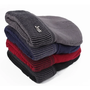 Close-up of four thick knit beanies showing ribbed texture and metal Jeans logo tags