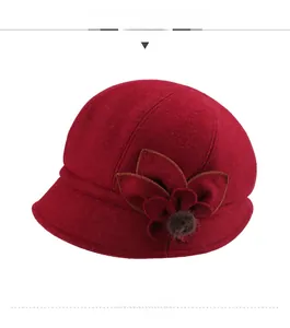 Front view of elegant red wool felt bucket hat with fabric flower and faux fur detail
