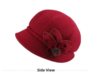 Side view of a burgundy winter wool felt hat featuring 3D floral accents and fur balls