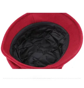 Detailed view of the warm quilted black lining inside the red wool winter basin hat