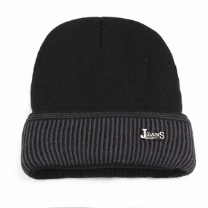 Close-up of black knit beanie with grey striped cuff and metal JEANS brand plaque