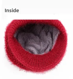 Detail view of red knitted hat featuring thick grey plush fleece lining for warmth