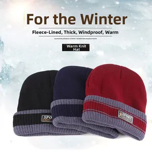 Close-up of thick knit hats with warm fleece lining in black, navy, and burgundy