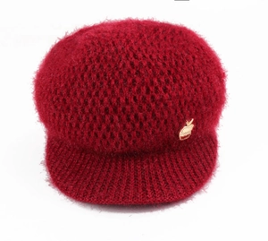 Winter knitted newsboy hat for women in dark red featuring a golden apple ornament