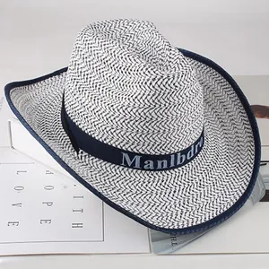 Detail of breathable straw cowboy hat showing blue trim and lettered band texture