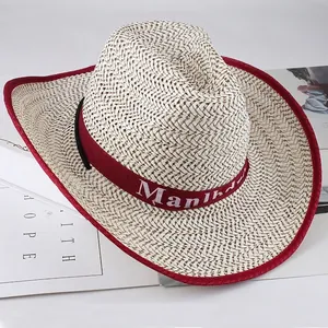 Detail view of woven straw cowboy hat with red trim and decorative band edge