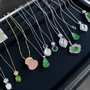 Collection of S925 silver necklaces with agate jadeite pendants on black velvet