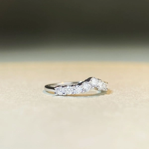 Macro shot of V-shaped S925 silver ring with seven round brilliant-cut moissanite stones
