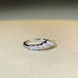 Detailed macro view of S925 sterling silver wavy ring with sparkling round moissanite