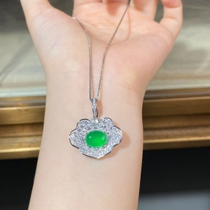 Macro detail of S925 silver Ruyi necklace with green jadeite pendant on human hand